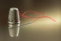 Needle, thread and red thimble Royalty Free Stock Photo