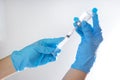 A needle and a vaccination bottle in the doctor`s hand