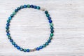 Necklace from polished azurite beads on gray Royalty Free Stock Photo