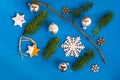 Needles twigs, stars, snowflakes and christmas bulbs on blue background Royalty Free Stock Photo