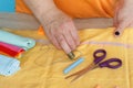 Needlework and hand quilting in the workshop of a tailor woman - on the desktop of thread, scissors. Royalty Free Stock Photo