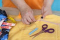 Needlework and hand quilting in the workshop of a tailor woman - on the desktop of thread, scissors. Royalty Free Stock Photo