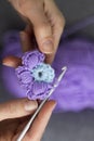 Needlework or handmade process: blue, and violet crocheted unfinished flower