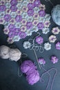 Needlework or handmade process: blue, violet and grey crocheted flowers