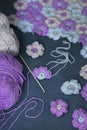 Needlework or handmade process: blue, violet and grey crocheted flowers