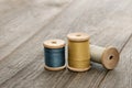 Needlework and hobby concept, wooden spools of thread on an old table, sewing and tailor accessories Royalty Free Stock Photo