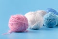 Needlework hobby concept. Wool clews on blue background Royalty Free Stock Photo