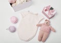 Needlework and knitting. Hobbies and creativity. Knit for children. Knitted toys rabbit, bodysuit and hat. Handmade toy hare. Baby Royalty Free Stock Photo