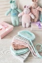 Needlework and knitting. Hobbies and creativity. Knit for children. Knitted toys rabbit and hat. Handmade toy hare. Baby cap. Yarn Royalty Free Stock Photo