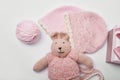 Needlework and knitting. Hobbies and creativity. Knit for children. Knitted toys rabbit and hat. Handmade toy hare. Baby cap. Yarn Royalty Free Stock Photo