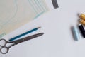 Needlework. pencil, ruler, scissors and patterns on a white table of a fashion designer Royalty Free Stock Photo