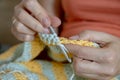 Needlework. Women`s hands close up crocheting children`s plaid. Crochet hook Royalty Free Stock Photo