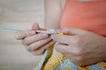 Needlework. Women`s hands close up crocheting children`s plaid. Crochet hook Royalty Free Stock Photo