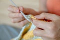 Needlework. Women`s hands close up crocheting children`s plaid. Crochet hook Royalty Free Stock Photo