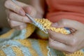 Needlework. Women`s hands close up crocheting children`s plaid. Crochet hook Royalty Free Stock Photo