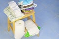 Needs for babies: cloth diapers, nappy liners, changing pad are prepared on wooden stool.