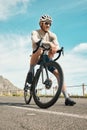 He needs a rest. Full length shot of a handsome mature man taking a break while cycling outdoors.