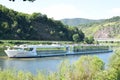 Neef, Germany - 09 02 2021: white long passenger ship waiting in the Mosel near Neef and the river lock Royalty Free Stock Photo