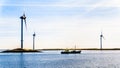 Fishing Boat and Wind Turbines at the Oosterschelde inlet at the Neeltje Jans island in Zeeland Province in the Netherlands Royalty Free Stock Photo