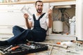 Negative emotional man plumber holding pipe Royalty Free Stock Photo