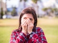 Negative feelings concept - shocked beautiful 20s girl covering her mouth and nose with hands for emotions or bad odor Royalty Free Stock Photo