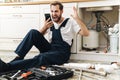 Negative man plumber work in uniform indoors Royalty Free Stock Photo