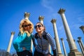 Negative space of two young adult women standing and smiling next to Captiol Columns in Washington DC National Arboretum Royalty Free Stock Photo