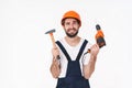 Negative thinking young man holding drill and hammer Royalty Free Stock Photo