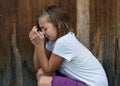 Neglected girl child cry in front of door alone Royalty Free Stock Photo