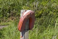 A neglected life saving buoyancy aid at a small footbridge on the Solent Way beach path on Southampton Water near Titchfield Commo Royalty Free Stock Photo