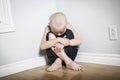 Neglected lonely child leaning at the wall Royalty Free Stock Photo