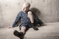 Neglected lonely child leaning at the wall Royalty Free Stock Photo