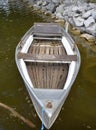 Neglected old and rotten rowboat made of metal and wood Royalty Free Stock Photo