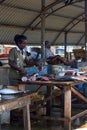 Man chopping fish and selling at Negombo fish market.