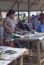 Women chopping fish and selling at Negombo fish market.