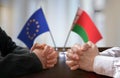 Negotiation between Belarus and European Union. Belarusian and Europen flags in background