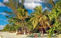 Beautiful caribbean tropical relaxing white sand beach, palm trees, restaurant bar Royalty Free Stock Photo