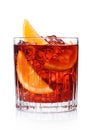 Negroni Cocktail in crystal glass with ice cubes and orange slices on white background with reflection Royalty Free Stock Photo