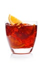 Negroni Cocktail in luxury crystal glass with ice cubes and orange slices on white background with reflection Royalty Free Stock Photo