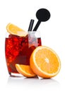 Negroni Cocktail in luxury glass with ice cubes and orange slices with straw and disc stirrer on white background with reflection Royalty Free Stock Photo