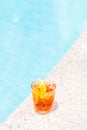 Negroni cocktail near a pool at the resort bar or suite patio. Luxury resort, vacation, room service concept Royalty Free Stock Photo