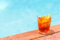 Negroni cocktail near a pool at the resort bar or suite patio. Luxury resort, vacation, room service concept Royalty Free Stock Photo