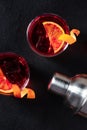 Negroni cocktails with blood oranges and peel, shot from above