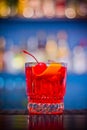 Negroni. Red drink cocktail in glass jar with cherry and orange peel Royalty Free Stock Photo