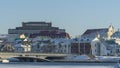 Neighborhood of old houses and modern buildings in winter. Retro versus modern style. Contrast in architecture.