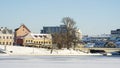 Neighborhood of old houses and modern buildings in winter. Retro versus modern style. Contrast in architecture. Royalty Free Stock Photo