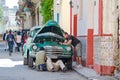 Classic car repair, Havana Cuba. Without a workshop and the right tools, the men try to weld a classic car. Royalty Free Stock Photo