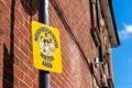 A Neighbourhood Watch area sign on a lamppost in a British street with a terraced brick house in the background Royalty Free Stock Photo