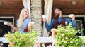 Neighbours drinks coffee at balcony and speaking.