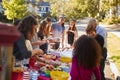 Neighbours standing around a table at a block party Royalty Free Stock Photo